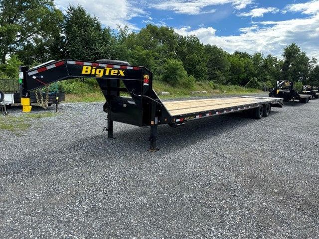 Gooseneck flatbed trailer used for equipment and material hauling