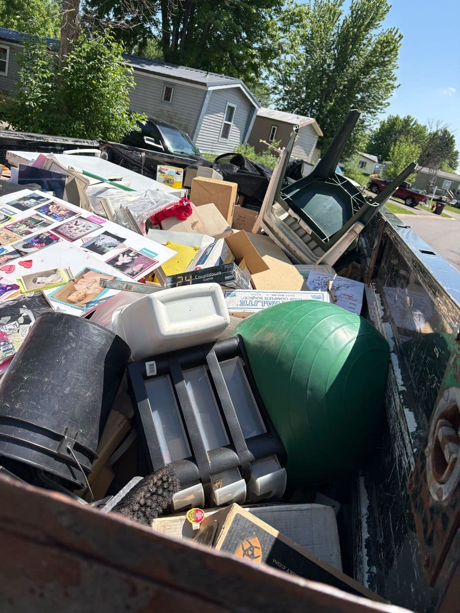 Pickup truck bed loaded with household junk during a residential removal job